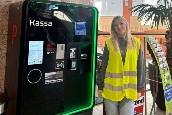 Frau neben Parkscheinautomat